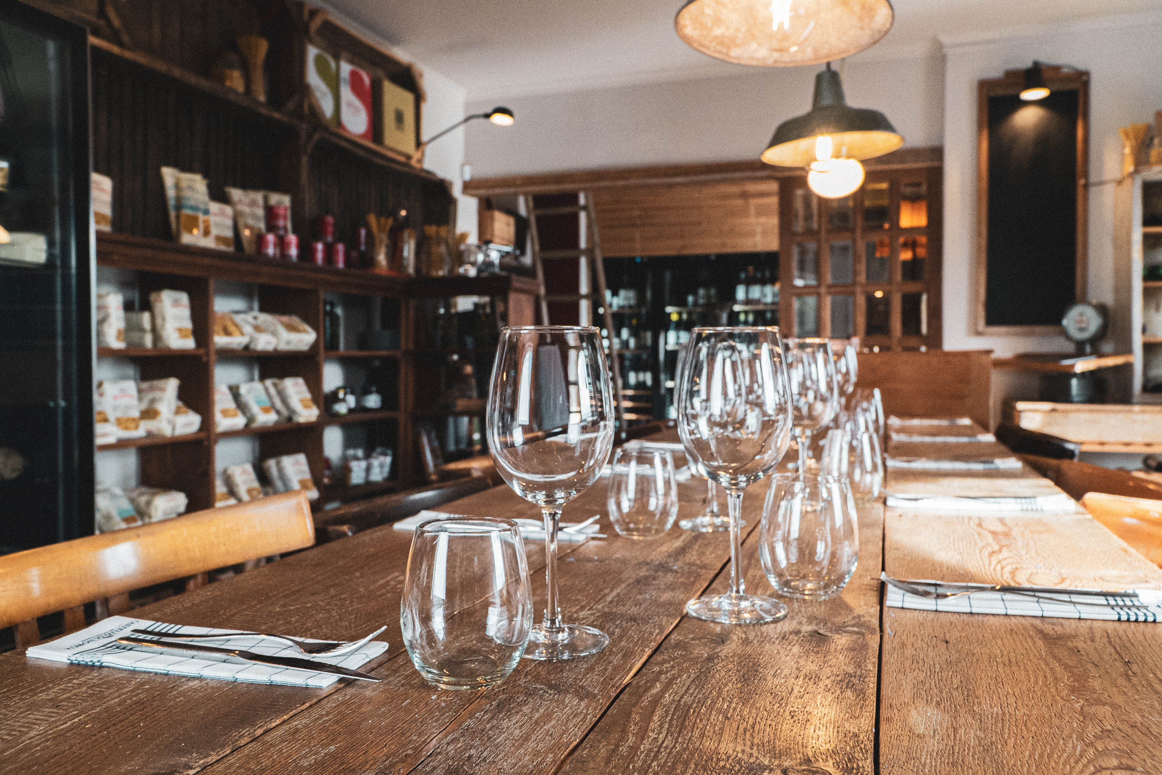 A wooden table with wine glasses on it